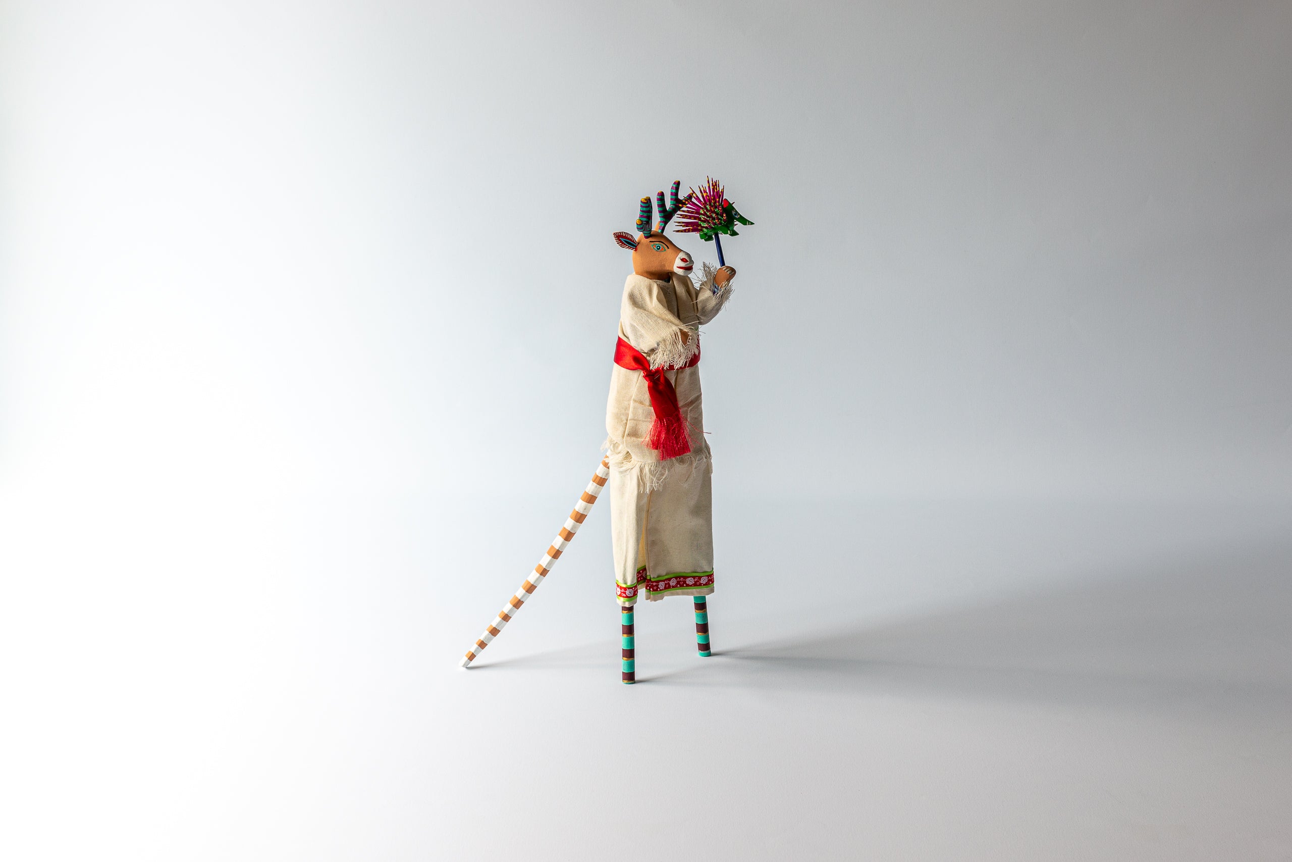 Stilt dancer by Martin Melchor Angeles in an off-white dress.