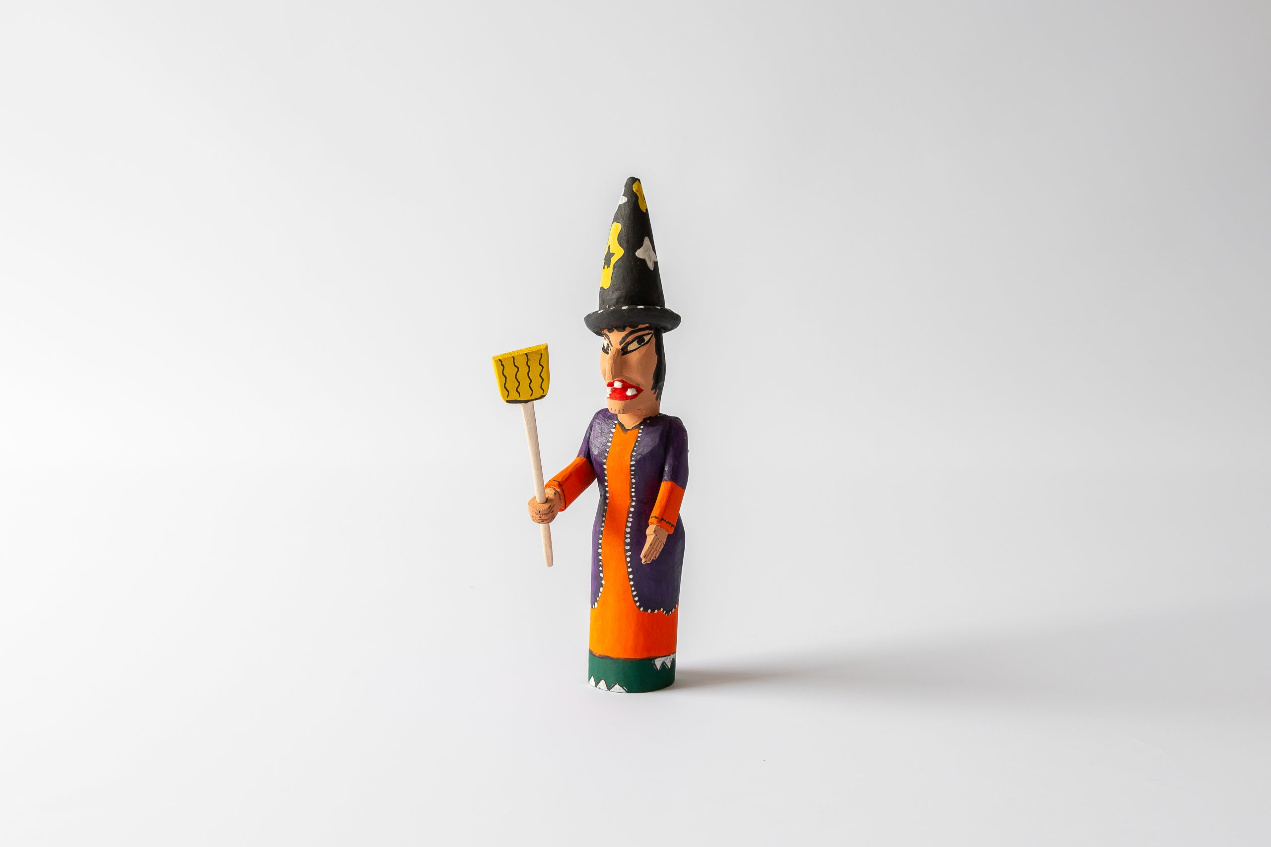 Witch carved in wood, with tall hat and broom